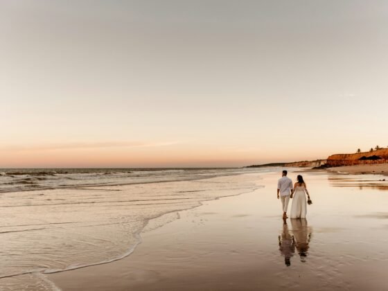 A just married couple walking down the beach