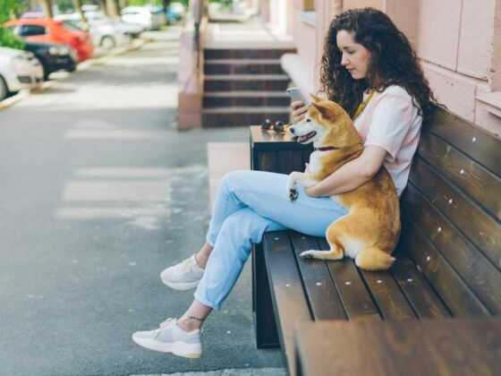 Women sitting on bench with her pet