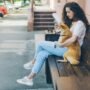 Women sitting on bench with her pet